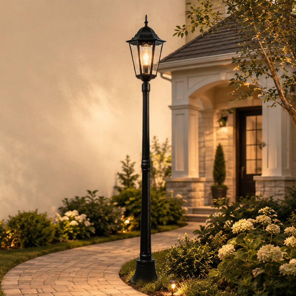 Black  post light with motion sensor along an evening garden path