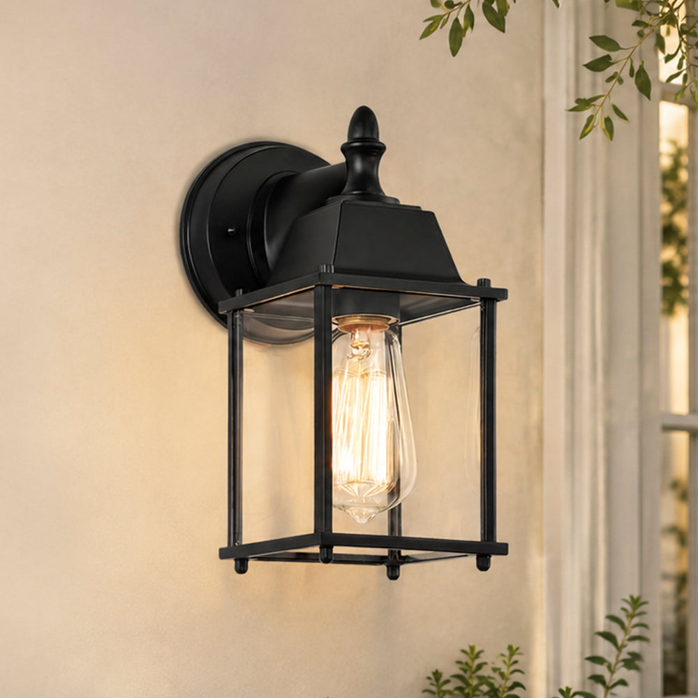 Black outdoor wall lantern beside a warm front porch entry